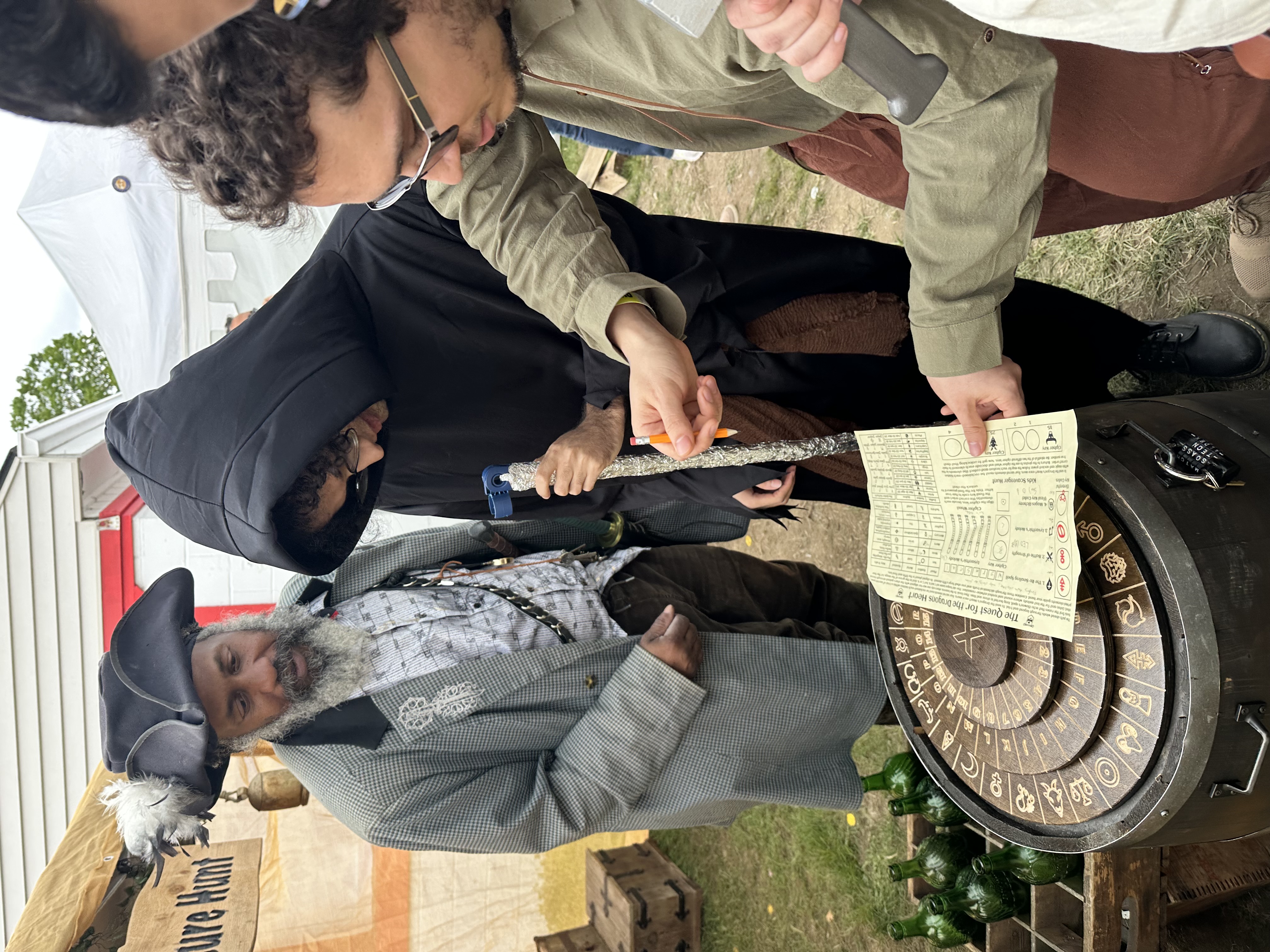 Pirate host guiding participants through the cipher wheel puzzle at X Treasure Hunt