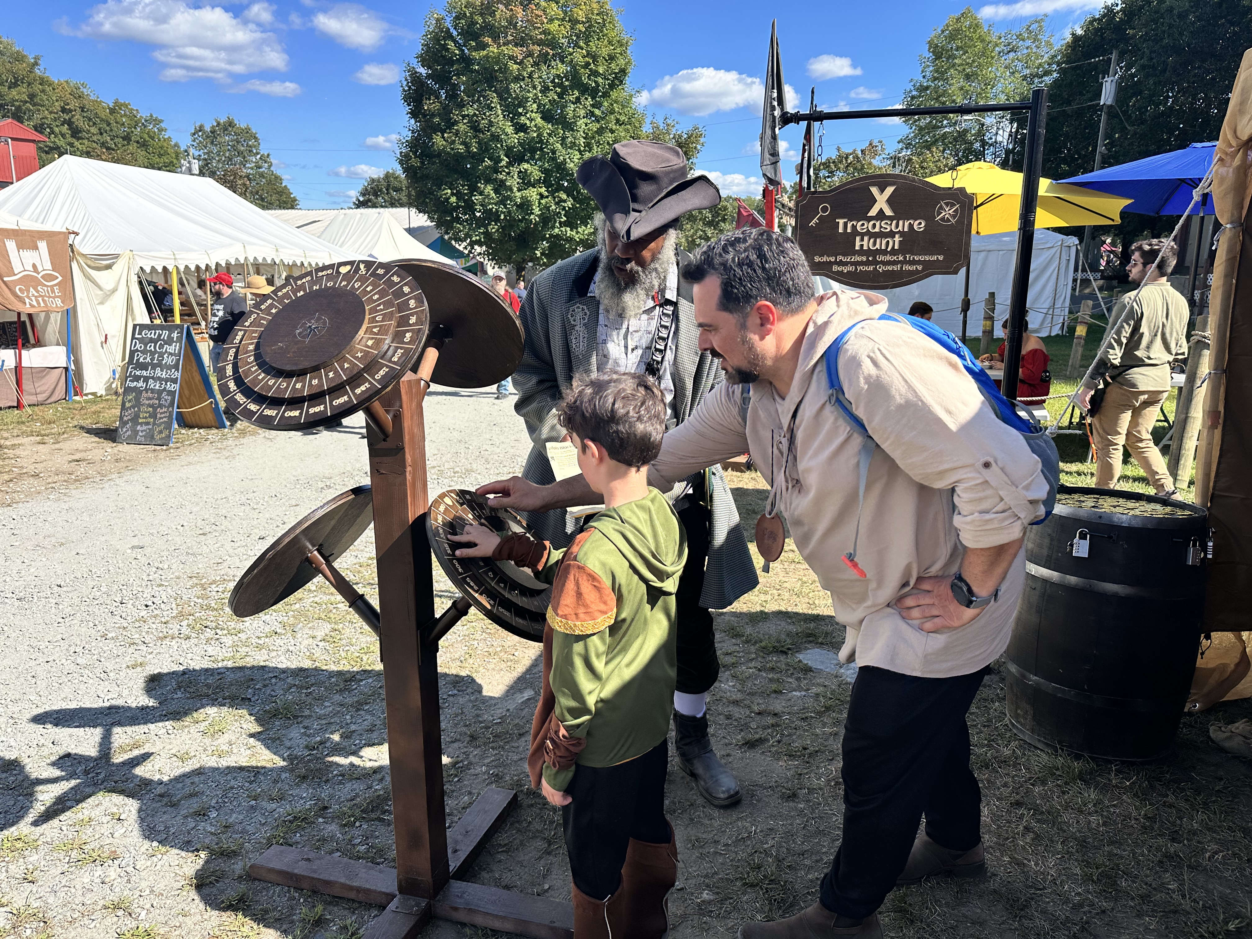 Father and son working the cipher wheel together at X Treasure Hunt