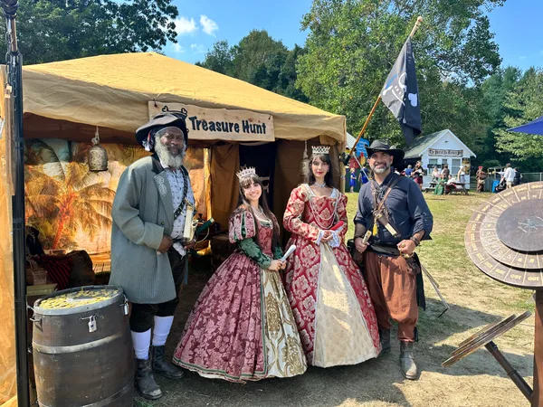 Renaissance queens posing with the pirate host at X Treasure Hunt