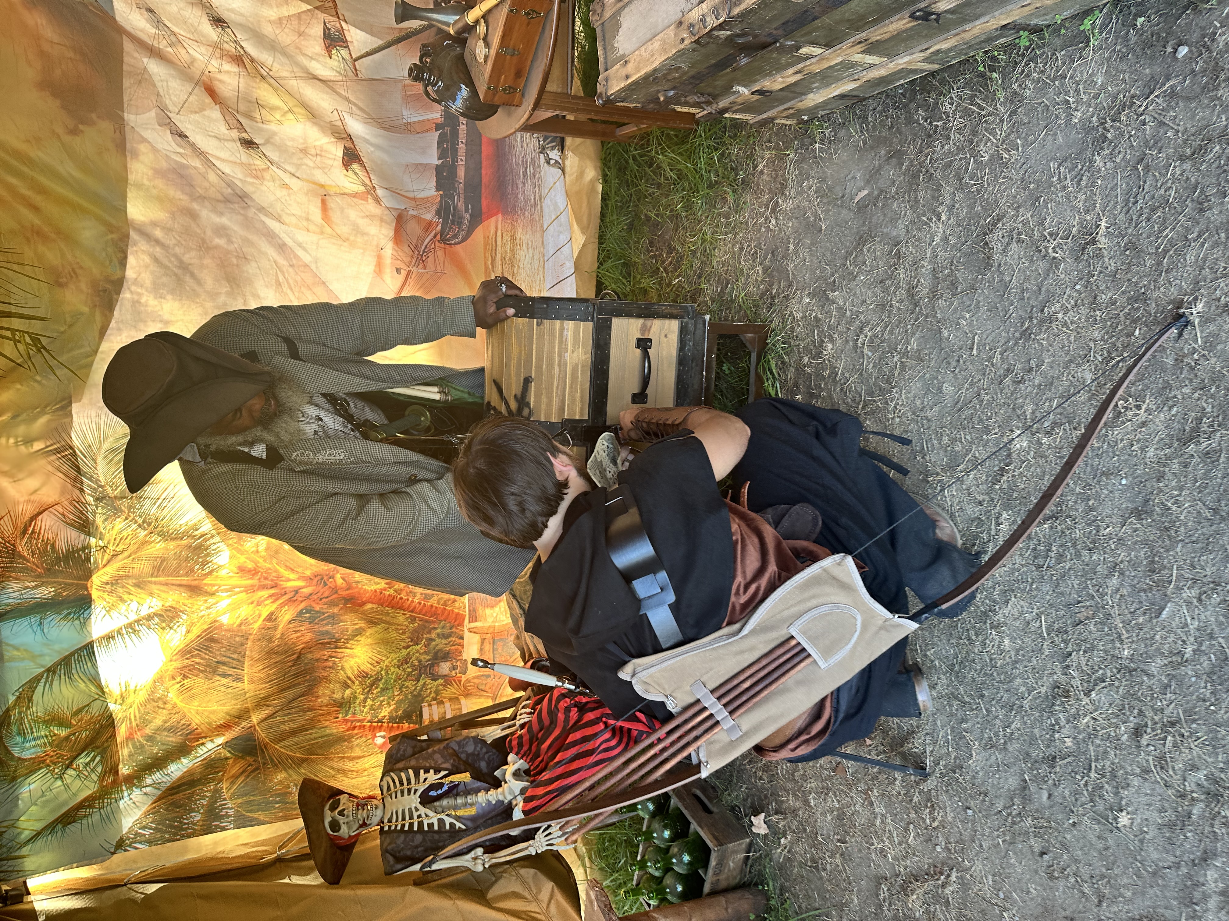 Young archer in Renaissance garb examining the treasure chest contents